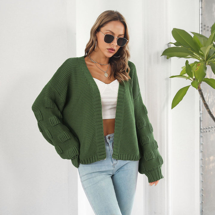Woman in chunky cable knit puff sleeve cardigan