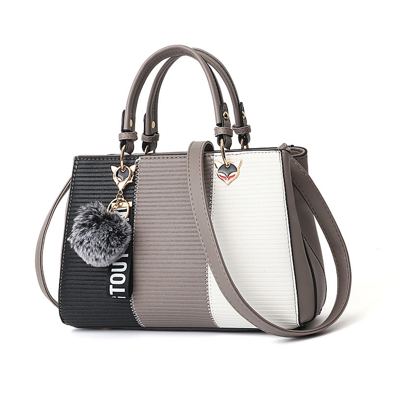 Colorblock handbag with pom-pom charm