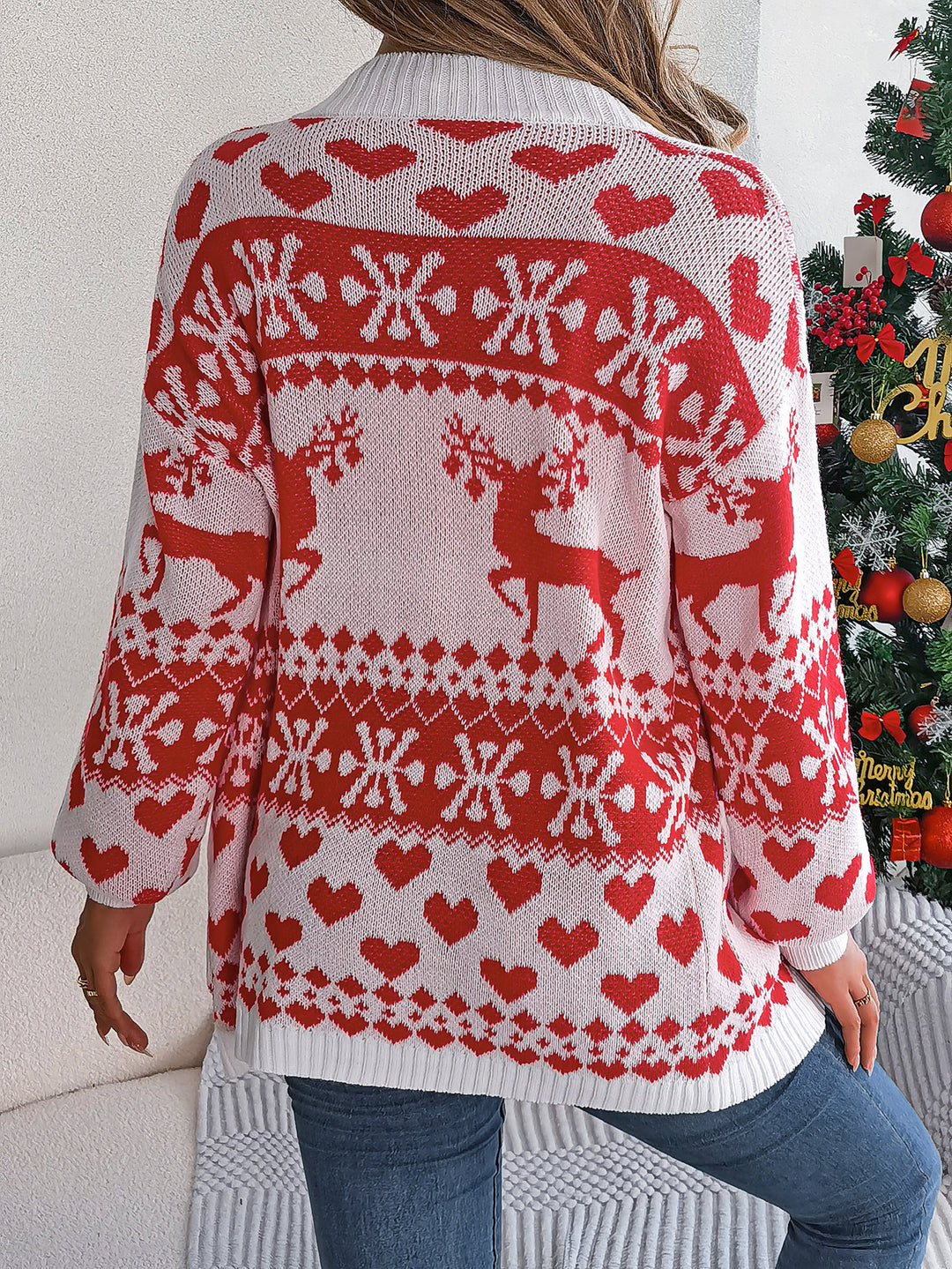 Woman in a reindeer knit cardigan