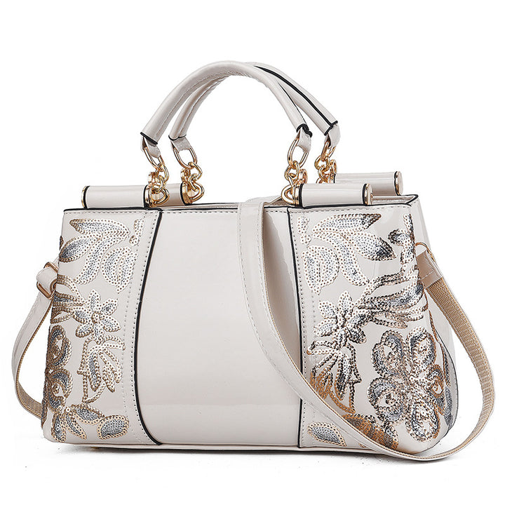 Sequin embroidered patent leather handbag