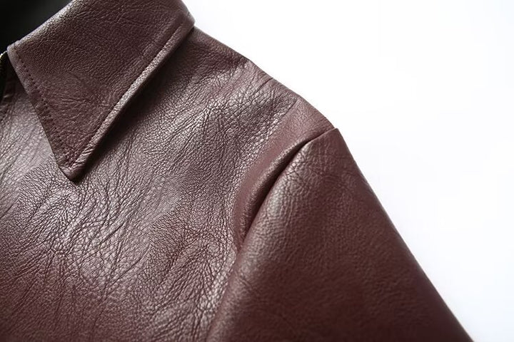 Woman in a cropped burgundy leather jacket