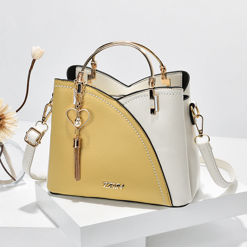 Color block handbag with heart tassel