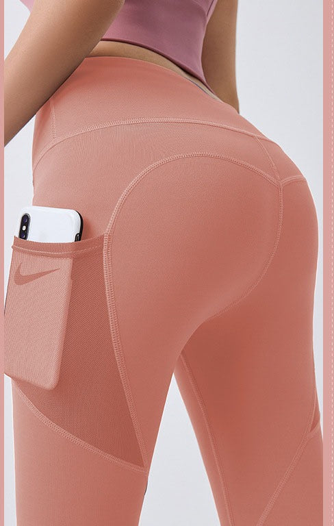 Woman wearing black high-waist leggings with phone pocket