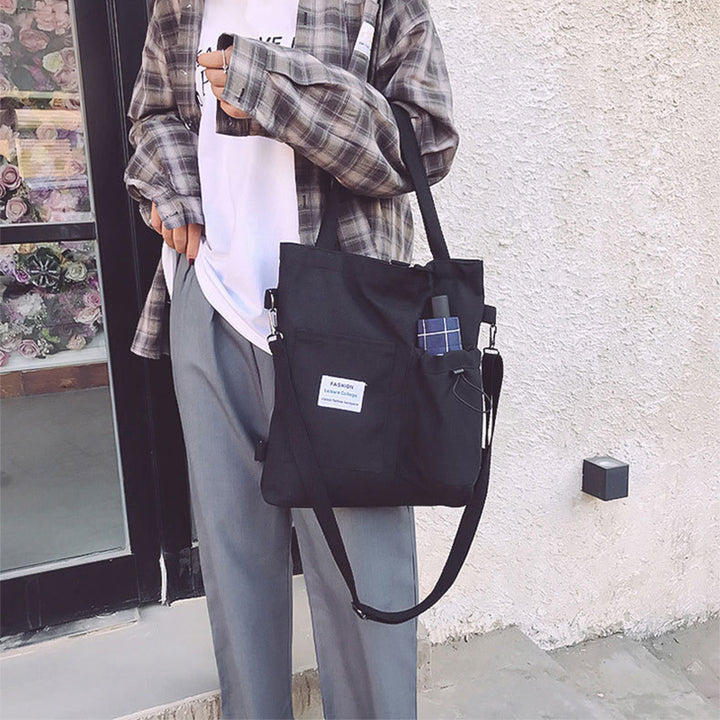 Canvas tote bag worn as a backpack