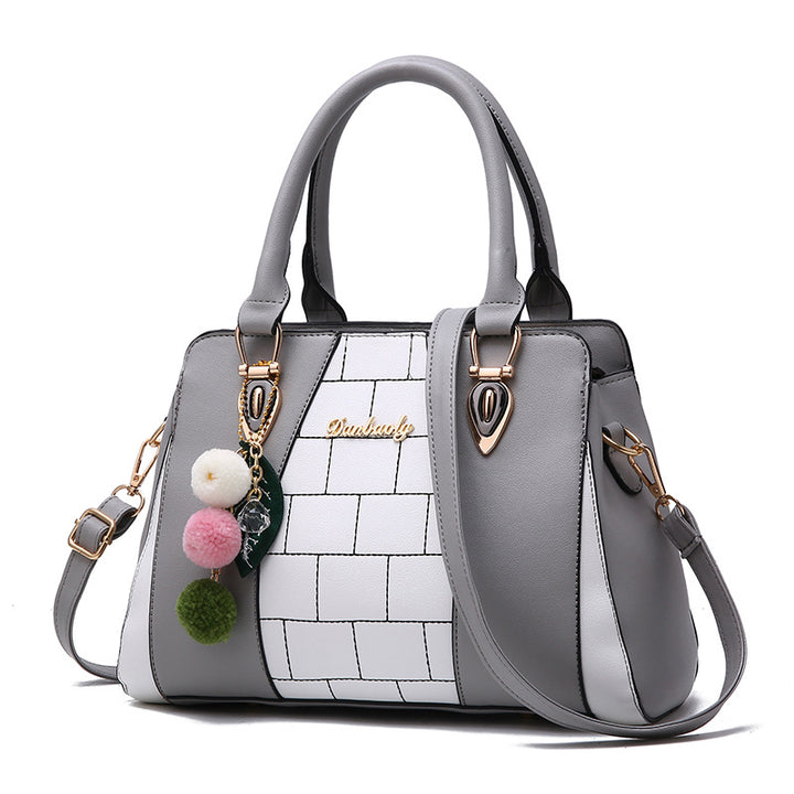 Two-tone handbag with pompom charm