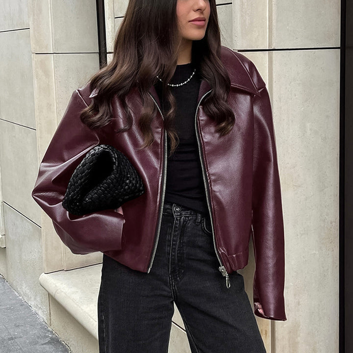 Woman in a cropped burgundy leather jacket