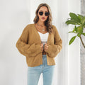 Woman in chunky cable knit puff sleeve cardigan
