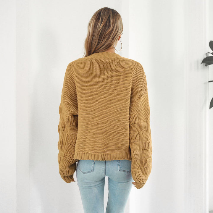 Woman in chunky cable knit puff sleeve cardigan
