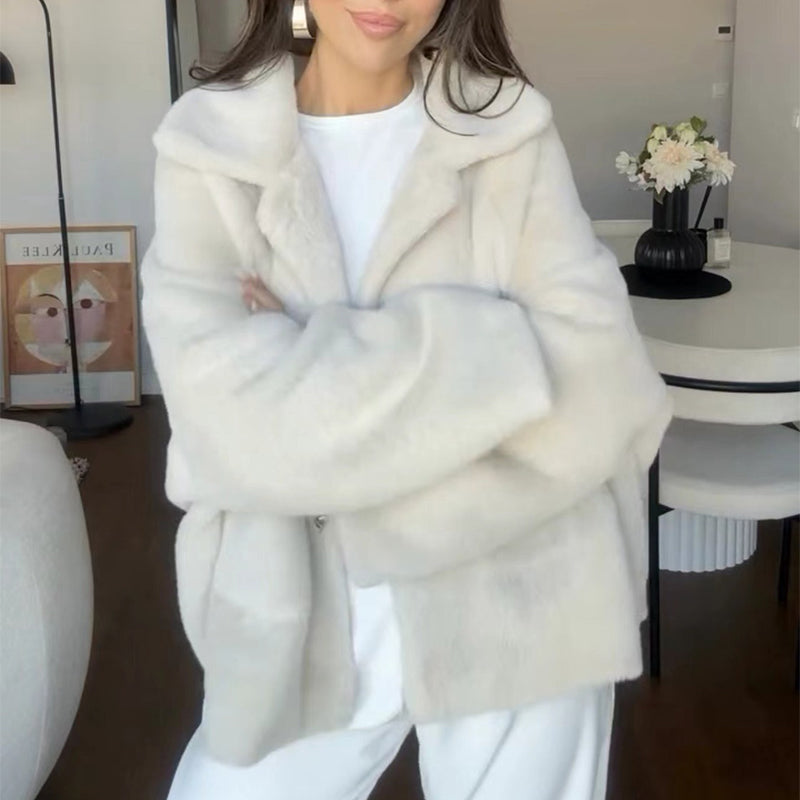 Woman in a short off-white teddy jacket